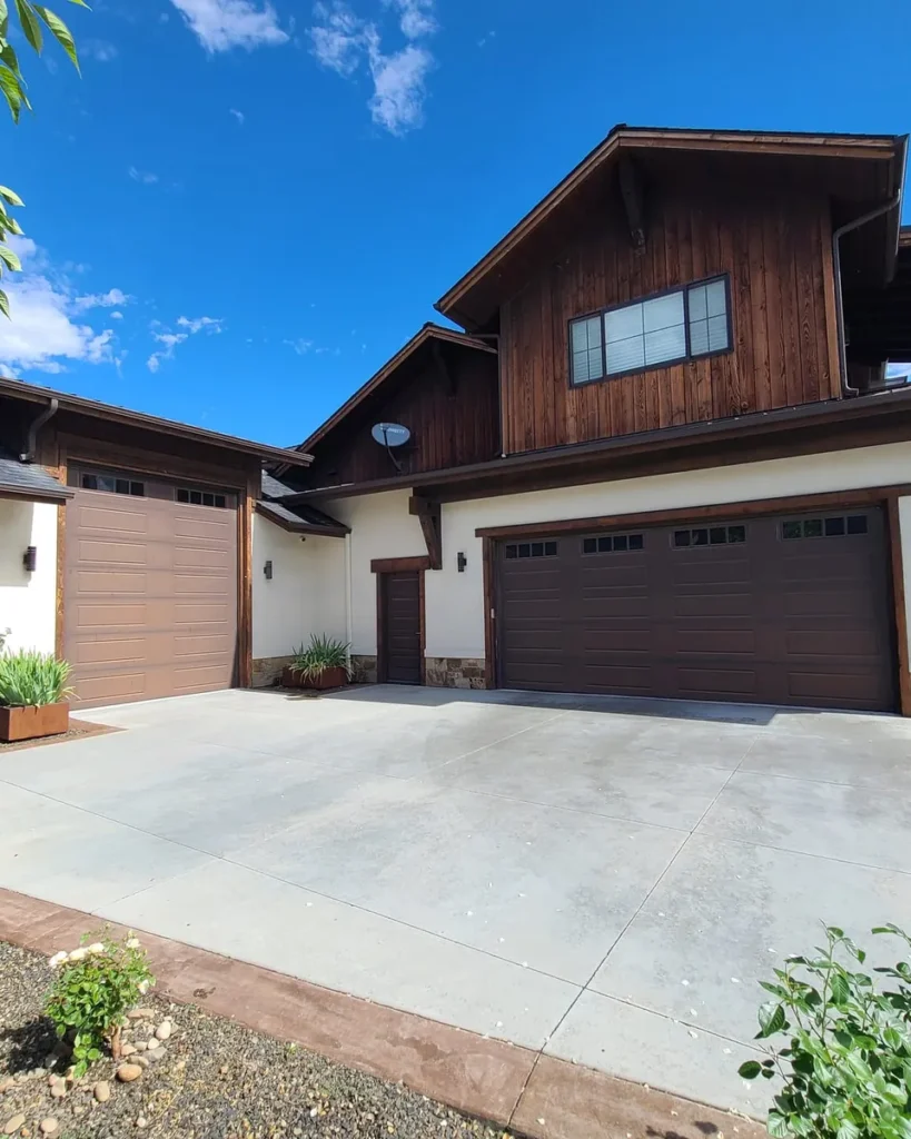 Freshly painted modern craftsman home exterior with vertical wood siding and stone in Eagle, Idaho