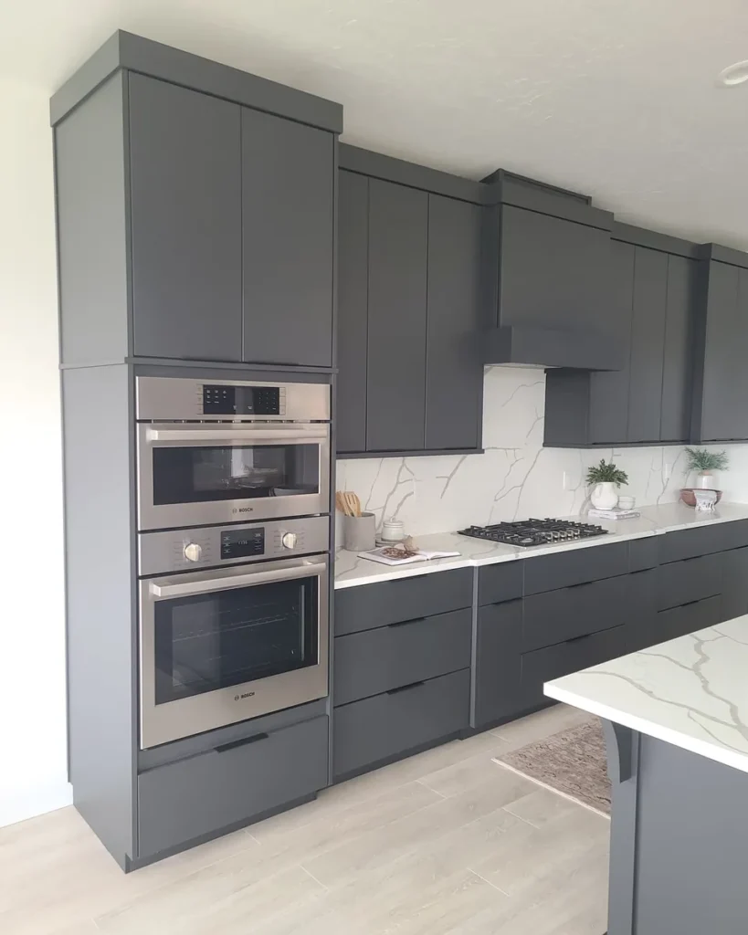 Refinished gray shaker kitchen cabinets with a marble backsplash in a Treasure Valley home